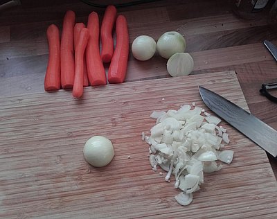 Möhren und Zwiebeln auf einem Schneidbrett